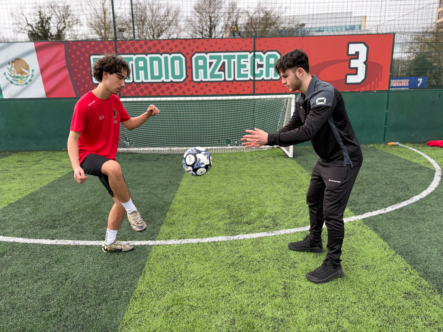 Technical football coach demonstrating drills.