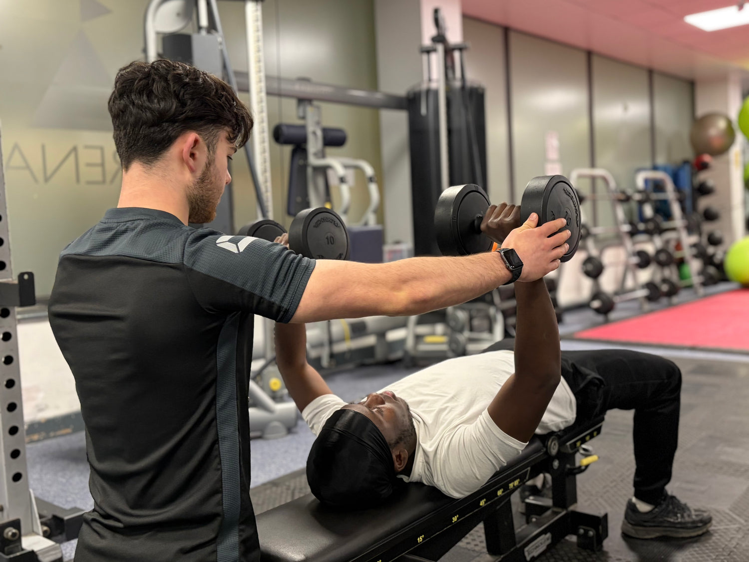 Personal Trainer leading a workout session in Kingston gym.